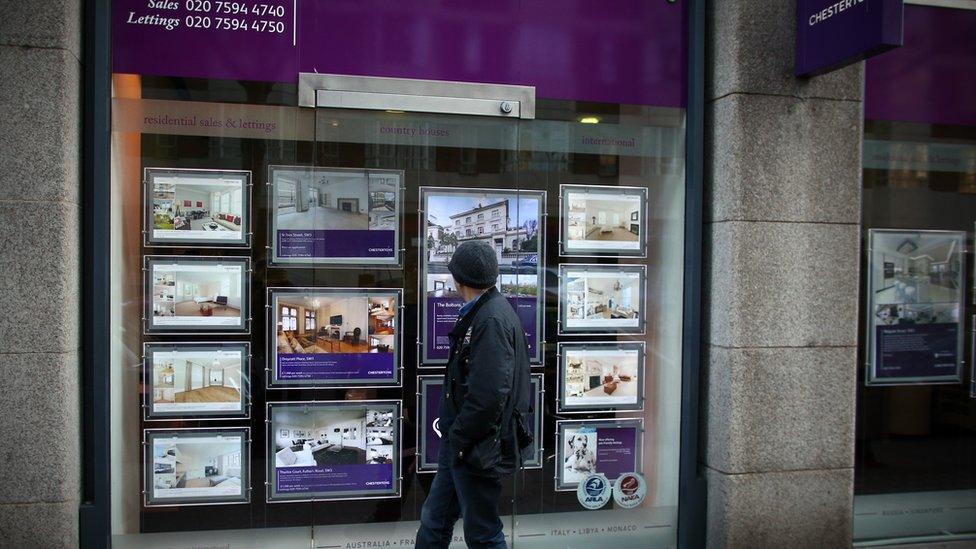 A man walks past an estate agency in West London