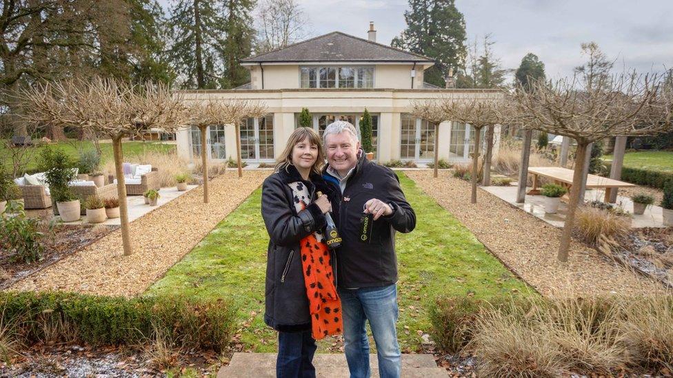 Amanda and Michael standing in front of their new home