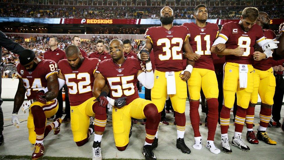 Washington Redskins players, some kneeling, during the anthem before a game against the Oakland Raiders