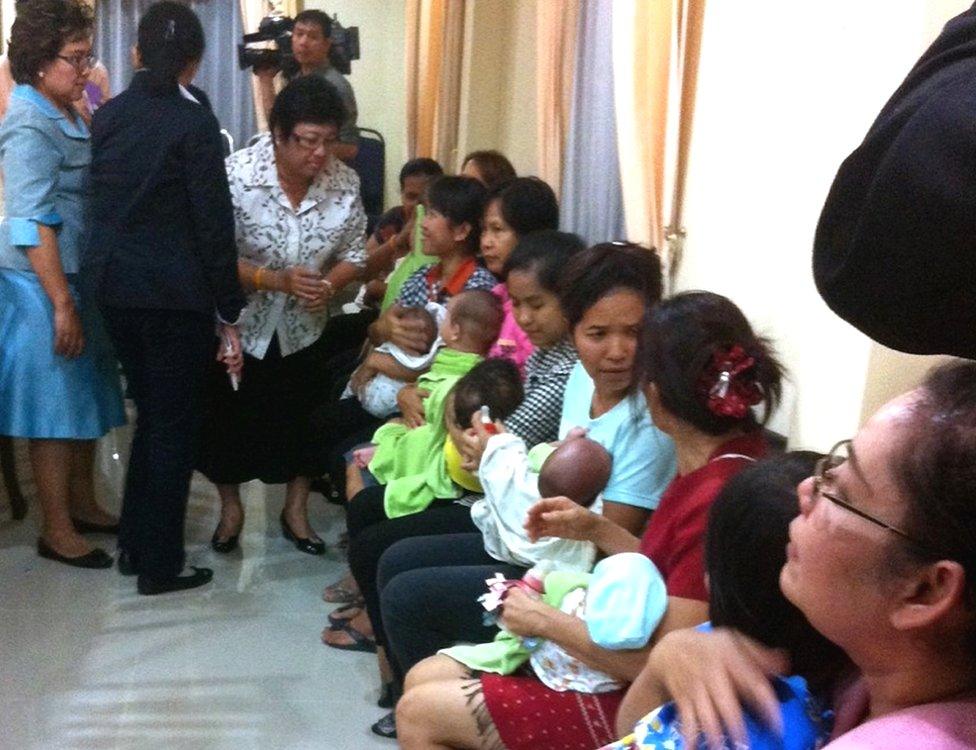 Thai nannies holding nine suspected surrogate babies after a police raid at a residential apartment on the outskirts of Bangkok, Thailand, 5 August 2014