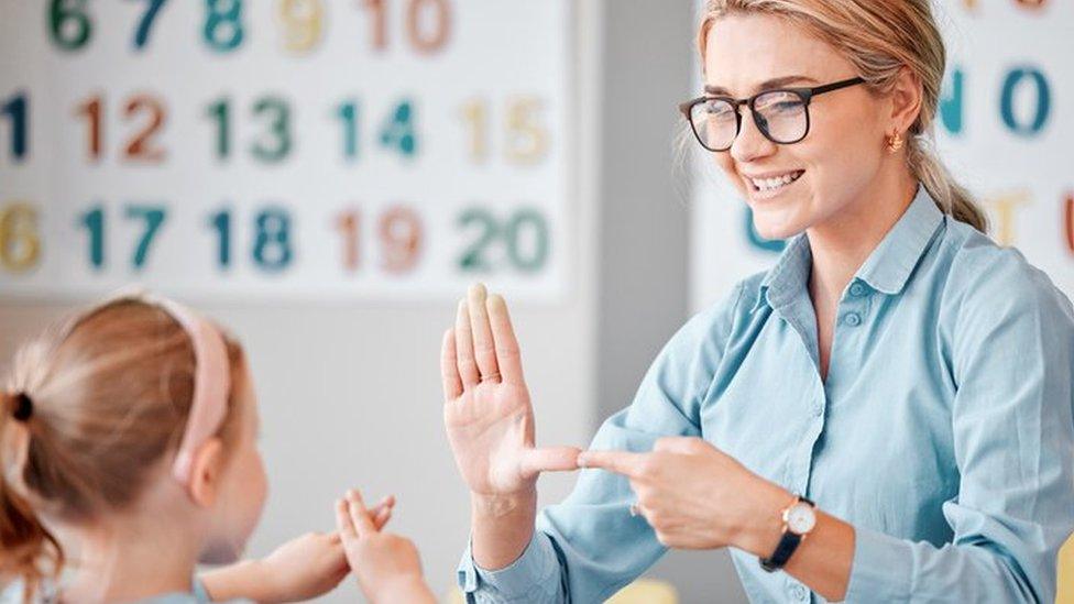 Child being taught BSL in the classroom