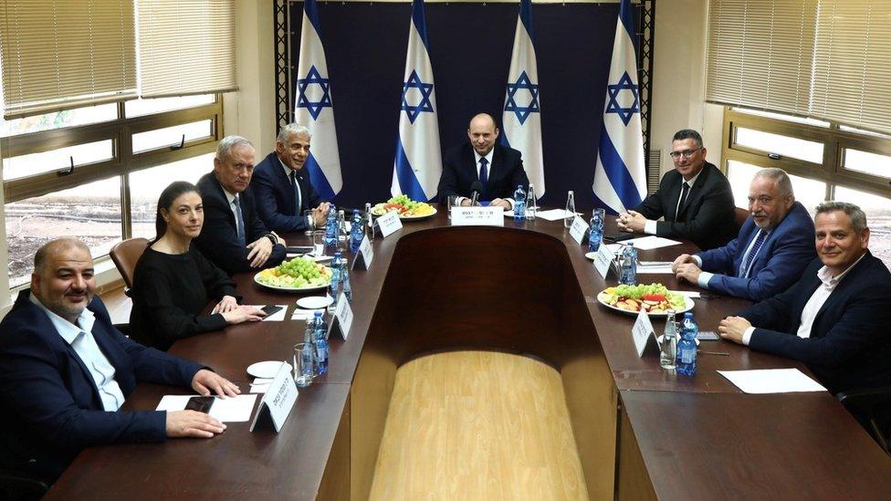 United Arab List party leader Mansour Abbas, Labour party leader Merav Michaeli, Blue and White party leader Benny Gantz, Yesh Atid leader Yair Lapid, Yamina party leader Naftali Bennett, New Hope party leader Gideon Saar, Yisrael Beiteinu party leader Avigdor Lieberman and Meretz party leader Nitzan Horowitz pose for a picture at the Knesset, Israel's parliament, before the start of a special session to approve and swear-in their new coalition government (13 June 2021)