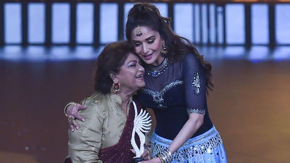 Bollywood choreographer Saroj Khan (L) hugs actress Madhuri Dixit.