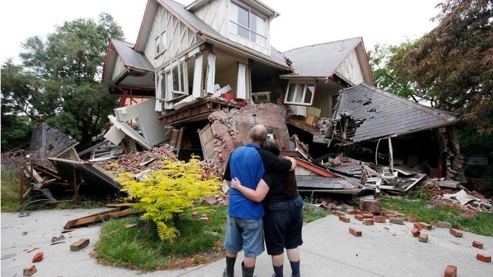 A couple look at their collapsed house in Christchurch, New Zealand (Feb 2011)