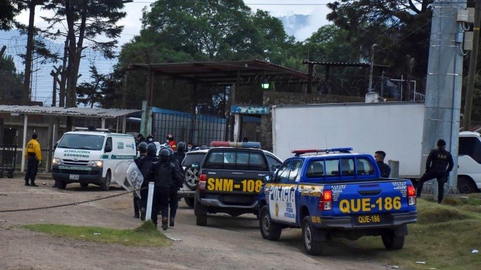 Riot police officers enter a prison after a riot broke out at the facility, in the municipality of Cantel