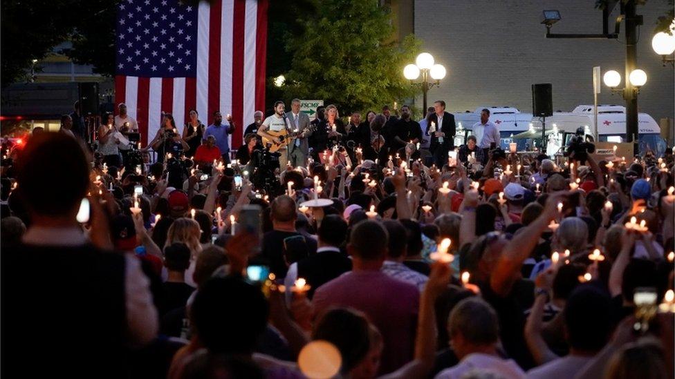 Local and state politicians and business leaders join community members for a vigil at the scene of a mass shooting in Dayton