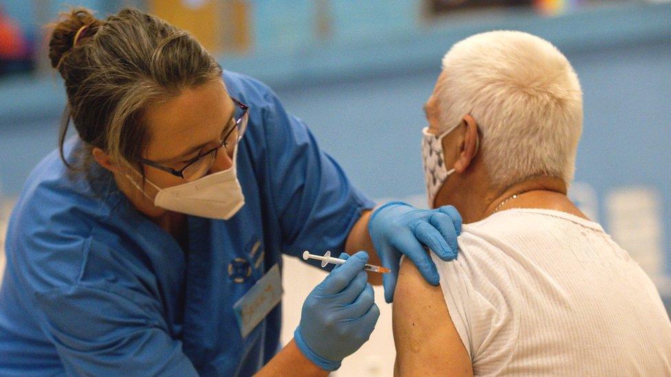 A nurse administers a Covid vaccine in Cwmbran, Wales