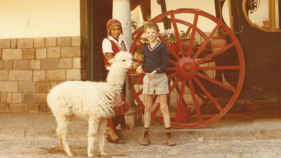 Kevin Eve with an alpaca in Peru