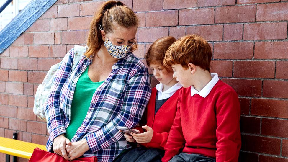 Stock image of a mother with her schoolchildren