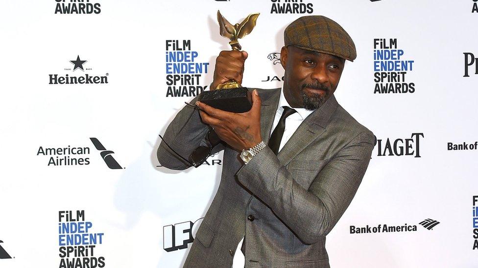 Idris Elba displays his award at the Independent Spirit Awards