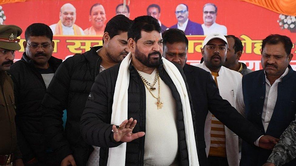 Wrestling Federation of India (WFI) president Brij Bhushan Sharan Singh (C) arrives to address a press conference on 20 January