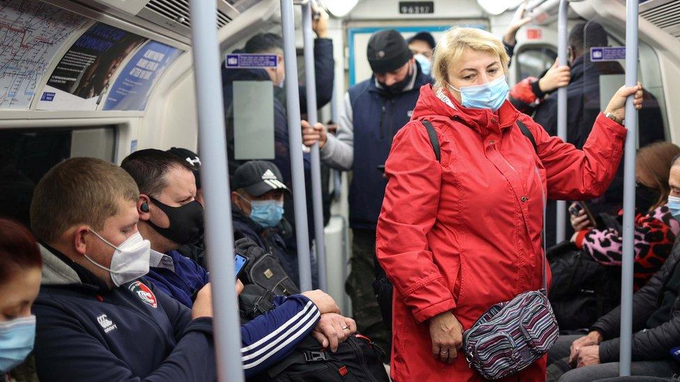 Commuters travel on a Jubilee line tube train during the morning rush hour, a