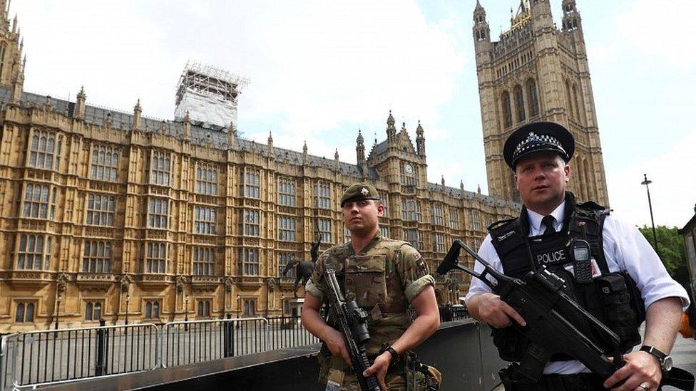 Police officer and soldier outside Parliament