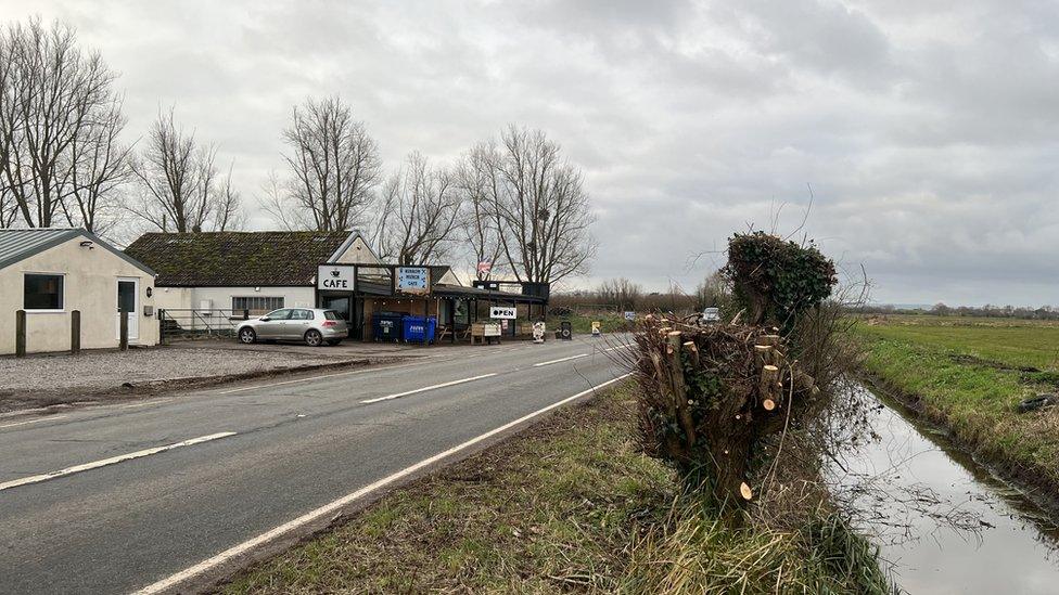 Café and main road next to a rhyne