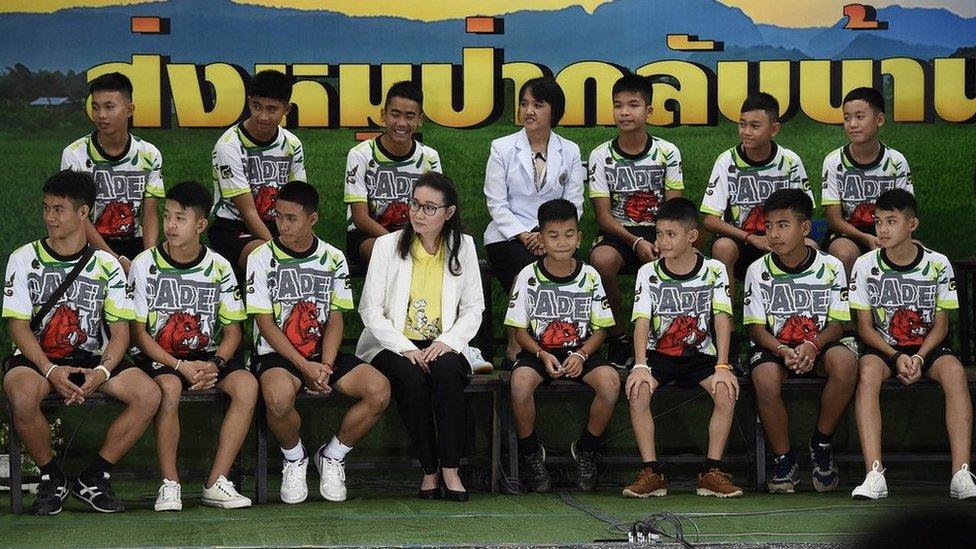 Twelve Thai boys and their football coach, rescued from a flooded cave after being trapped, attend a press conference in Chiang Rai on July 18, 2018, following their discharge from the hospital.