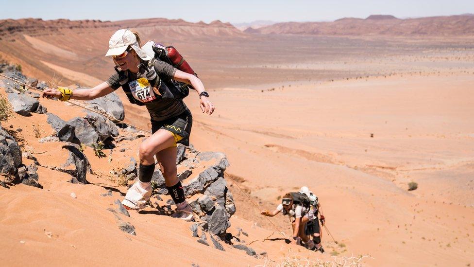 Sophie Raworth climbing up a sand dune at the Marathon des Sables