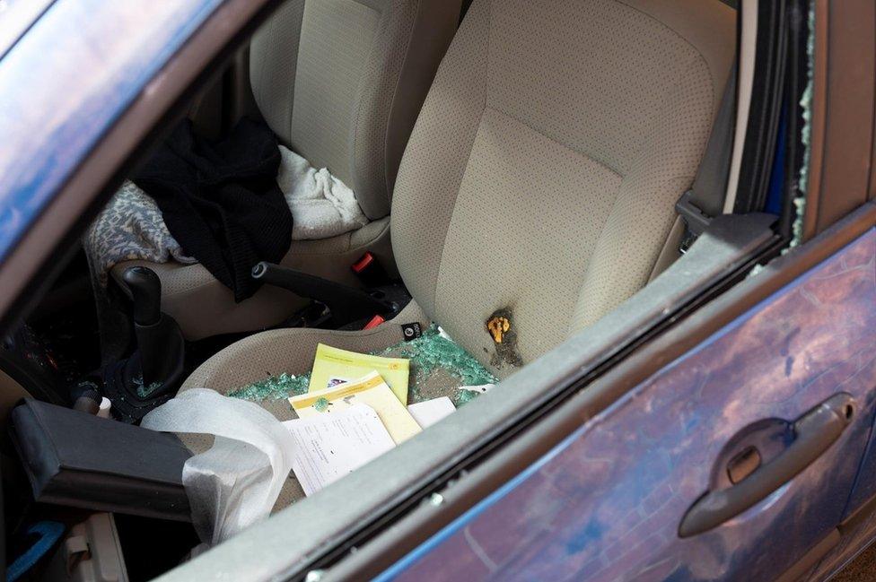 Damage to a car belonging to photographer Andrew Johnson