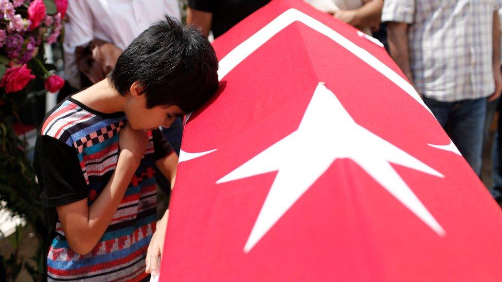 Relatives of a victim of the attack at Istanbul's airport mourn during a funeral on 30 June