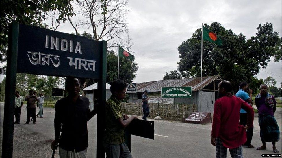 People stand at the Burimari land border crossing July 10, 2015 in Lalmonirhat District, Bangladesh