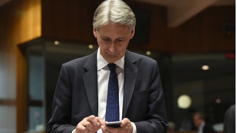 Chancellor Philip Hammond on phone