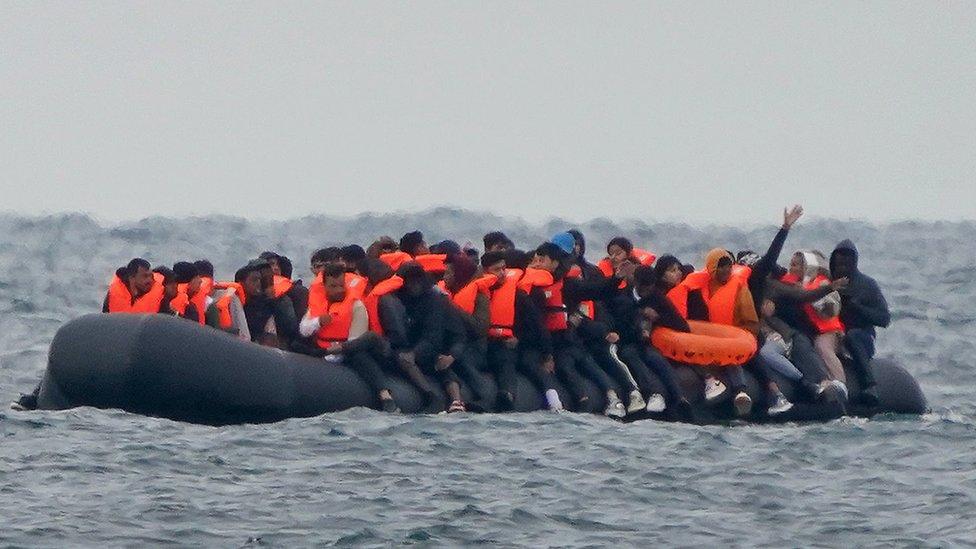 Group of people crossing the English Channel in a small boat