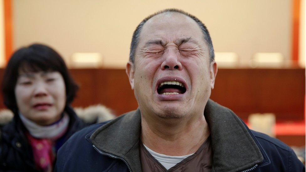 Wen Wancheng, whose son was among passengers onboard Malaysia Airlines flight MH370, cries as relatives arrive for a meeting with the airline representatives in Beijing, China, 18 January 2017.