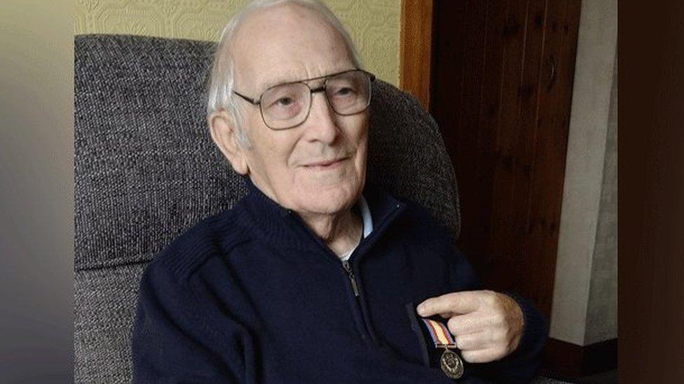 Bob Last holding his Nuclear test medal