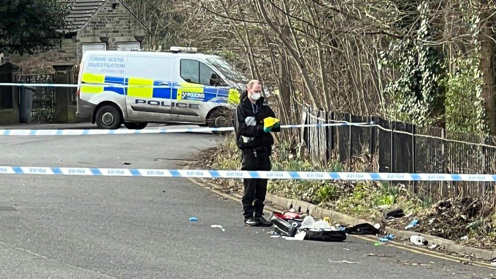 Investigations under way at the scene of the stabbing in King's Mill Lane, Huddersfield