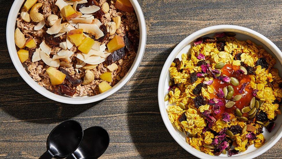 Two bowls of cereal with fruit on top