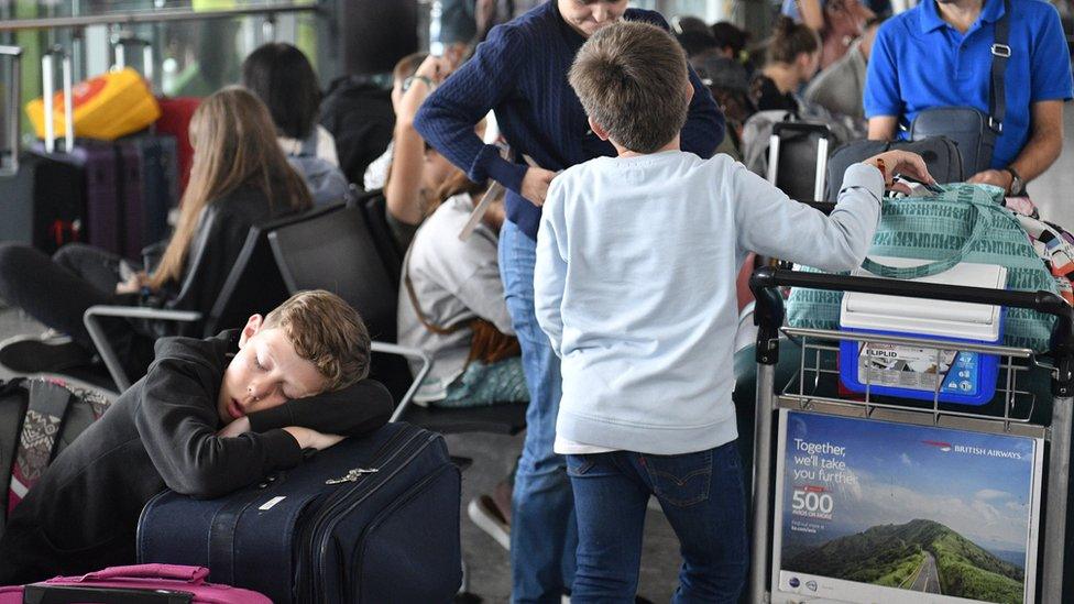 A youngster catches a nap at Heathrow