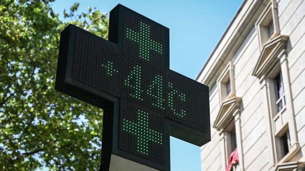 This photograph taken on June 17, 2022 shows a pharmacy sign displays the temperature of 44 Celsius degrees in the city of Montpellier in France