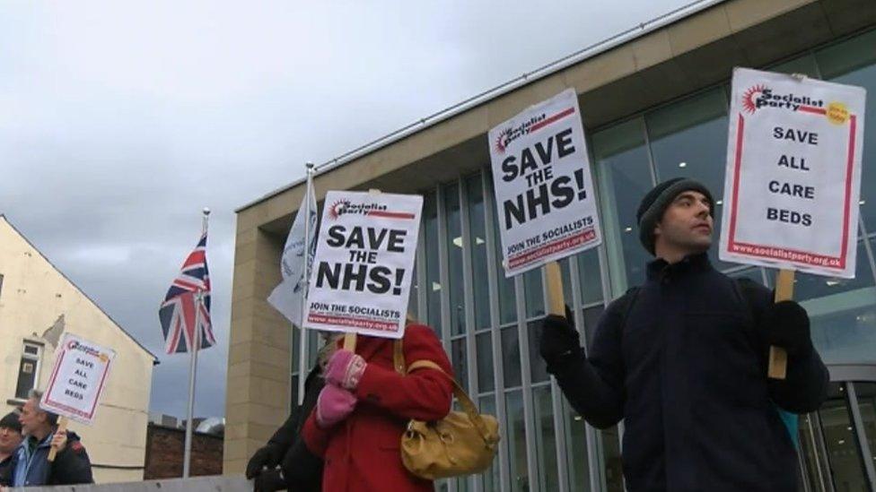 Protestors in Carlisle ahead of the council meeting