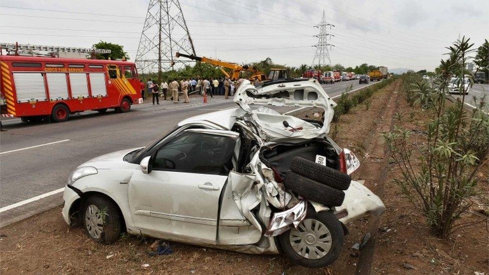 Indian rescue workers examine the scene of an accident on the Mumbai-Pune expressway near Shedung Panvel, that left 17 people dead and 28 injured, on June 5, 2016