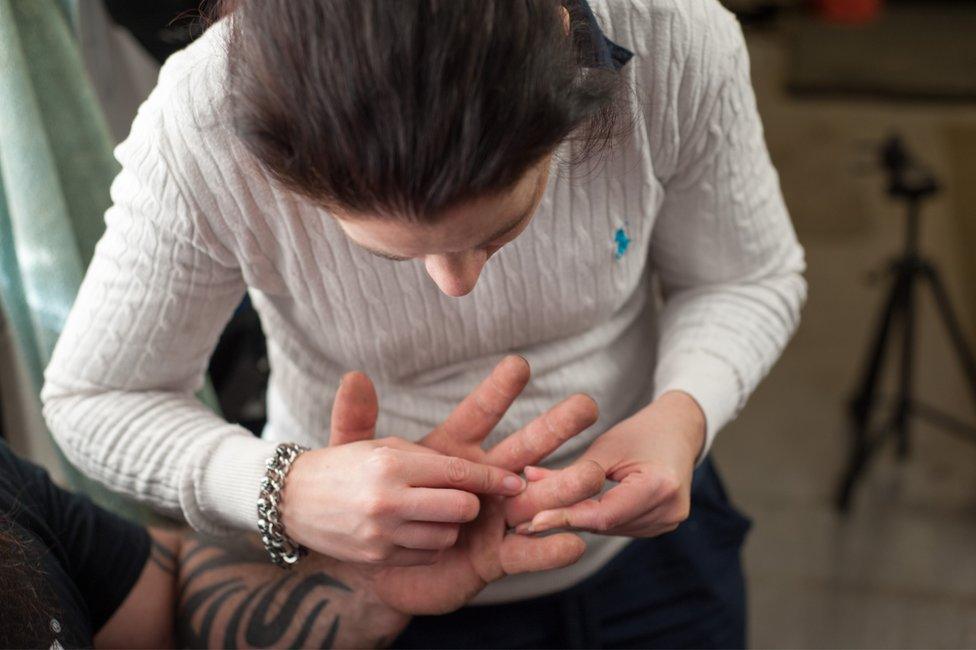 Nina helping Mikey remove a splinter