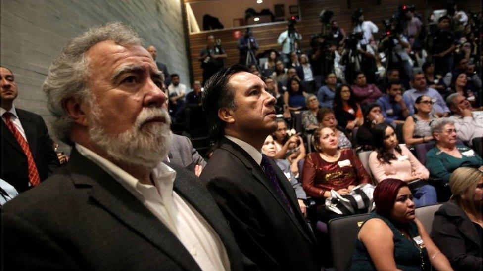 Deputy Secretary of Human Rights Alejandro Encinas Rodriguez (L) and Governor of Veracruz Cuitlahuac Garcia Jimenez (R), watch a screen in a public apology offered to relatives of five youths killed in 2016