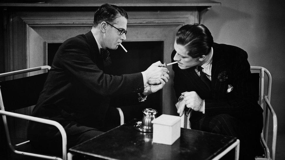 Two men smoking in the 1950s