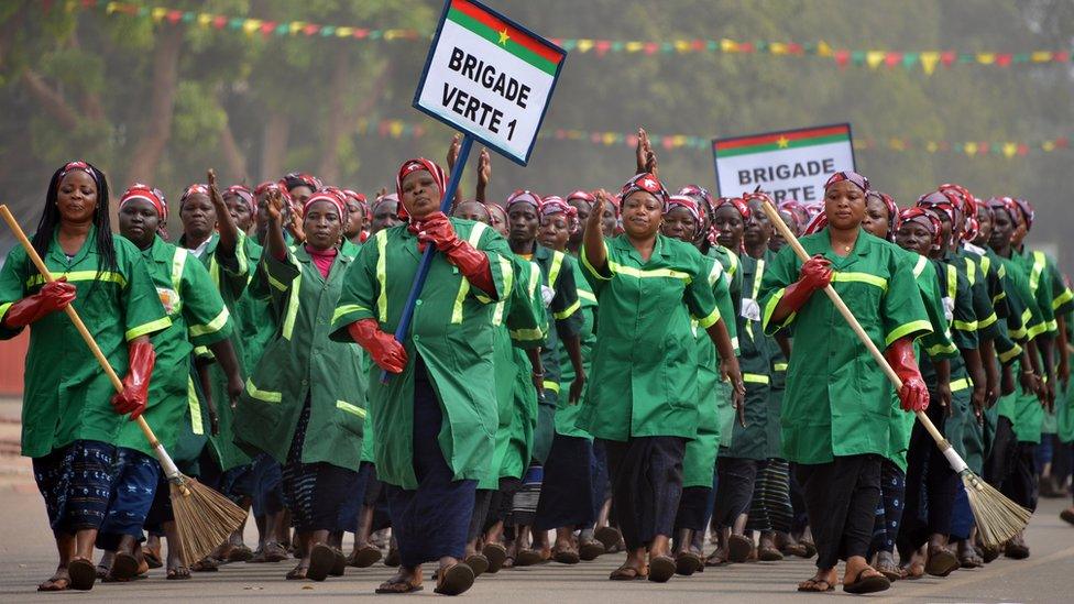 Workers from the Ouagadougou city hall march during celebrations marking Burkina Faso"s 55th anniversary of independence