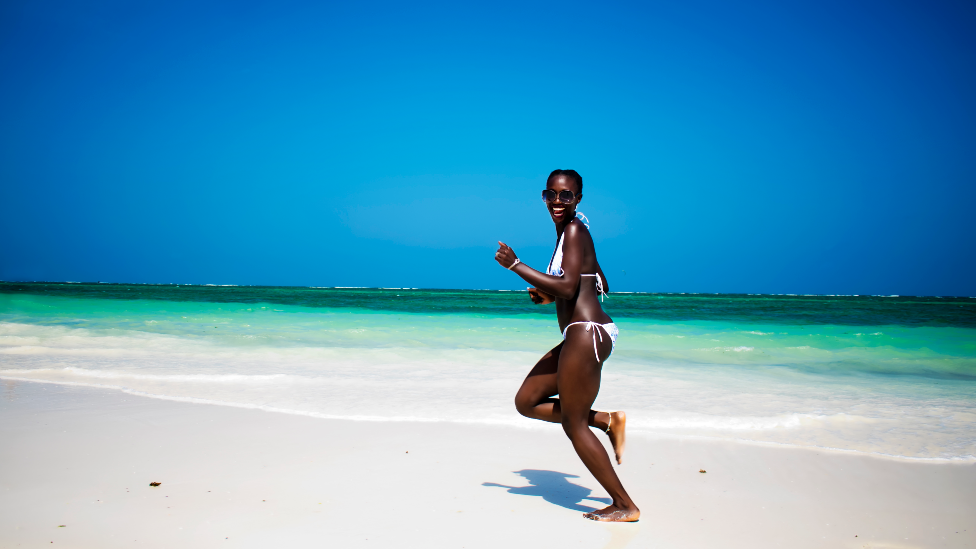 A woman running on a beach in Diani , Kenya - generic shot