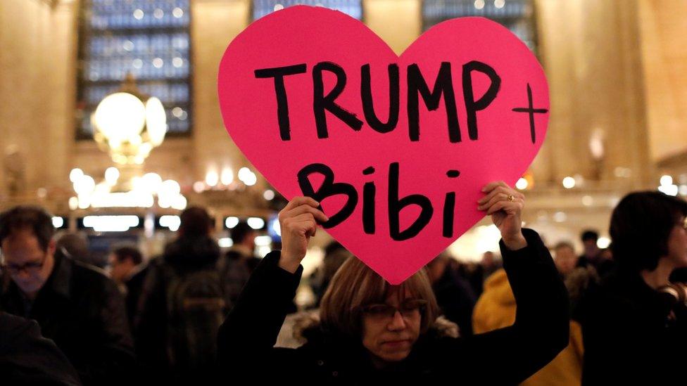 A demonstrator holds a sign during a "Muslim and Jewish Solidarity" protest against the policies of U.S. President Donald Trump and Israeli Prime Minister Benjamin Netanyahu at Grand Central Terminal in New York City, U.S., February 15, 2017