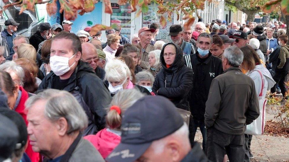 Residents in Mykoliav queue for humanitarian aid