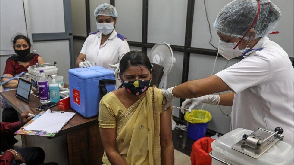 A woman has her vaccination