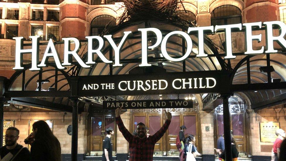 A picture of Harry Potter outside the entrance to the Harry Potter and the Cursed Child play in July.