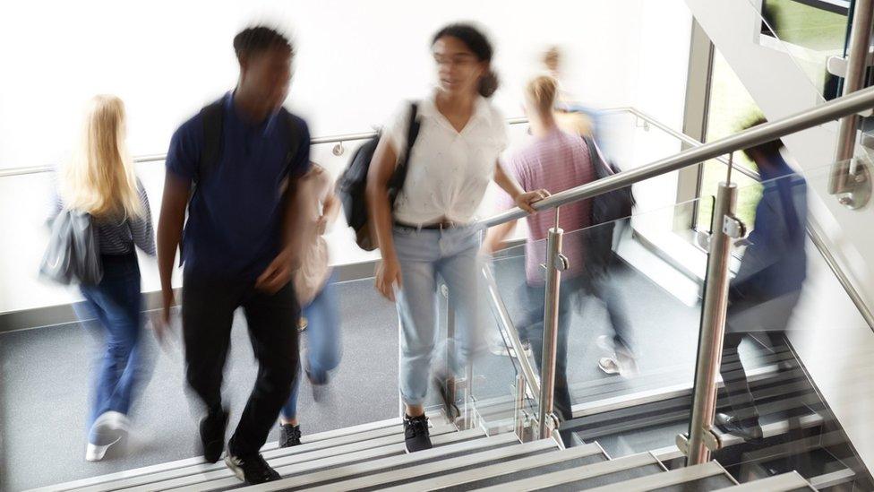 Blurred university students walking on stairs