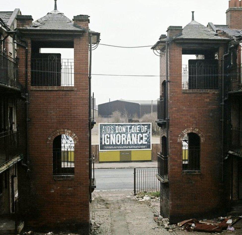 Two derelict buildings with AIDS health sign