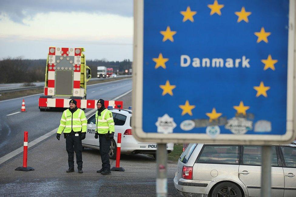 Danish police conducting spot checks on incoming traffic from Germany stand at the A7 highway border crossing near Padborg, Denmark