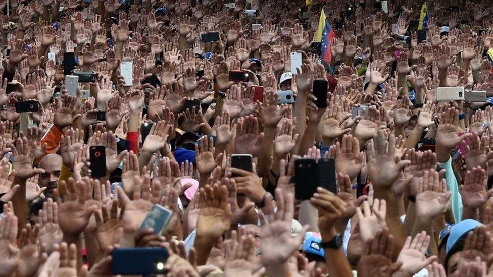 Venezuelans cheer Mr Guaidó as he declares himself interim president on 23 January