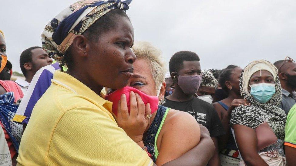 A woman cries as she waits for her son to arrive in Pemba on April 1, 2021, from the boat of evacuees from the coasts of Palma.