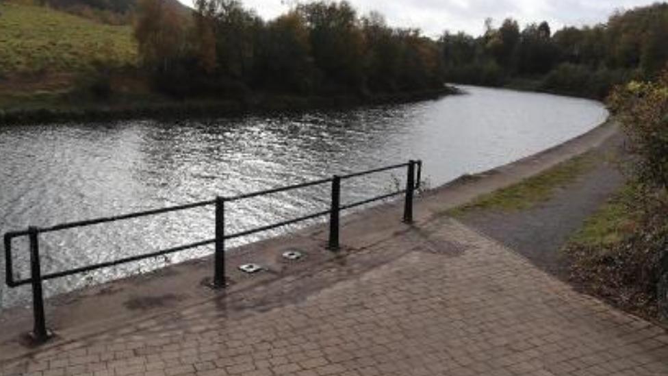 Pavement and railing next to the River Tawe