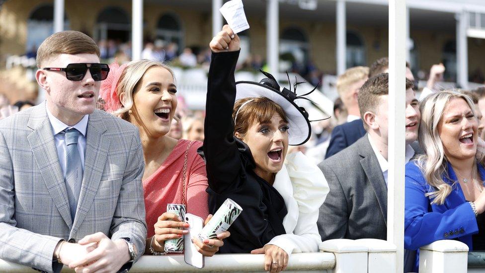 Woman celebrates win at Aintree