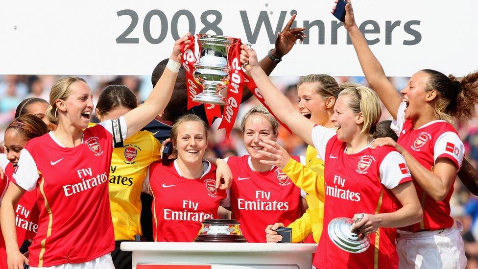 Faye White and Jayne Ludlow of Arsenal lead the trophy celebrations in 2008